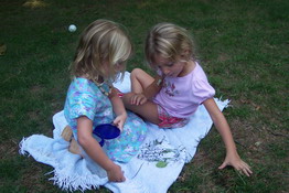 Danielle and Julia trying to find the ladybugs they had in their jar