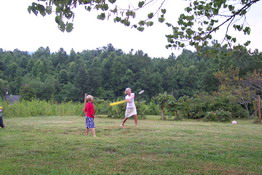 Cameron watching his mom swing big!