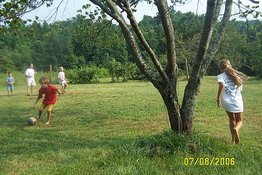 Heather and Alex were playing soccer around the tree