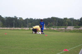 Daddy tying his cleats