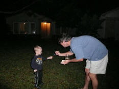 Mark helping little Daniel with a sparkler