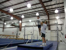 Patrick was surprised at how fast he spun around the bar.  His old coach wouldn't let do it on his own.