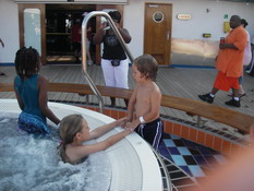 Ashley helping Ryan into the hot tub