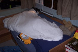 Patrick was sound asleep like this, fighting off the cold.