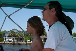 Mark was giving Alex a boat driving lesson