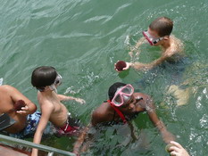 Another child showing Patrick a sea urchin he found