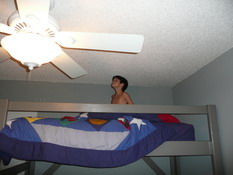 Touching his head to the ceiling