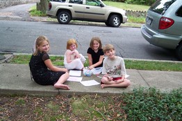 Sydney, Maggie, Kelsey and Alex doing artwork outside