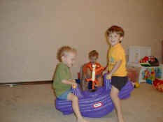 Nathan and Patch on the teeter-totter, with Carter watching
