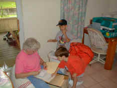 Grandma and the boys helping Mommy shred docs