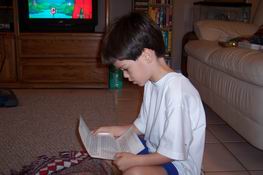 Reading his birthday letter from his piano teacher'