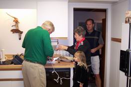 Julia's "helping" Nana and Papa cut the roast