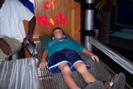 Alex trying out the bed of nails