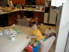 Patrick sat at the table with the grown ups