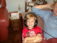 Alex listening to the TV with Grandpa's headphones