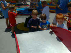 Alex and Patch racing their cars down the track