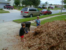 Patrick and Alex filling the wheelbarrow