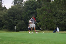 Waiting his turn to putt