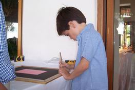 Patrick signing the guest book - actually, they framed the invitation and everyone signed the matte
