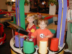 Alex and Patrick playing drums at Chuck E Cheese