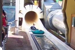 Alex shooting out of the water slide