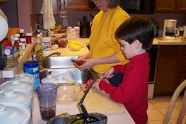 Patch helped me cut up strawberries for dessert