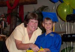 Alex getting his diploma from Mrs. Sheryl, his teacher