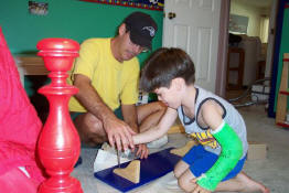 Even with only one arm, he's still Daddy's little helper.