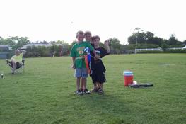 The boys and one of Alex's teammates all wrapped up in a football flag