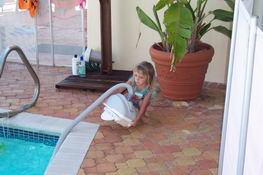 Julia really wanted to put the cleaner in the pool