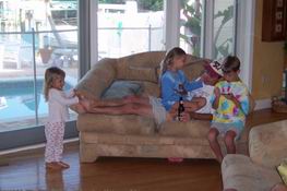 Heather cuddling with Uncle Mark while Julia tickles his feet!