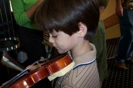 Trying out a small-sized violin