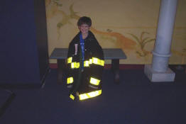 The jacket swallowed him!  The boots are under there somewhere!