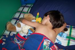 Patrick cuddles with ALL of his stuffed animals when he goes to sleep