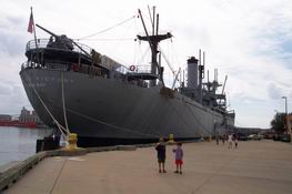 Waving in front of the USS Victory