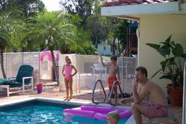 Heather and Alex playing catch with Mark (who's in the pool out of sight)