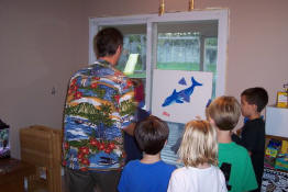Mark spinning the blindfolded kids for Pin the Fin on the Dolphin