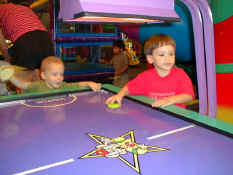 Patch helping Nathan play air hockey