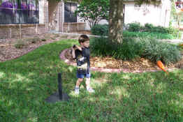 Patch playing tee ball with Grandma