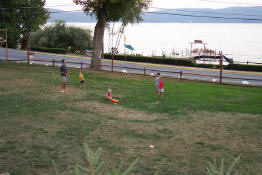 Mark, Patch, Preston, Christian and Alex playing baseball on the front lawn