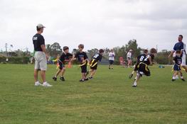 Alex playing quarterback making a handoff during warmup